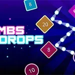 Napis Bombs Drops otoczony kolorowymi kwadratami z numerami na ciemnym tle