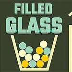 Napis FILLED GLASS nad szklanką wypełnioną kolorowymi kulkami na ciemnym tle