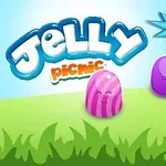 Kolorowe żelki w trawie z napisem Jelly Picnic i ikoną pucharu z liczbą +500 na tle błękitnego nieba