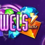Napis Jewels Blitz otoczony kolorowymi, błyszczącymi klejnotami na fioletowym tle