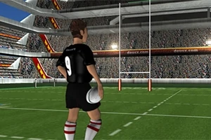 Zawodnik w czarnej koszulce z numerem 9, trzymający piłkę na boisku rugby, z widocznymi trybunami i bramką
