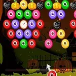 Kolorowe, okrągłe ikony z oczami, dyniami i zegarami na tle halloweenowym z domkiem i dyniami